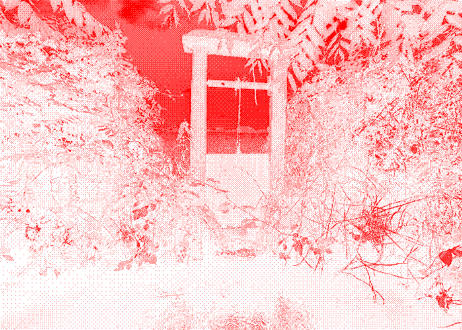 Stone sluice gate regulating water flow in a narrow vegetated ditch.